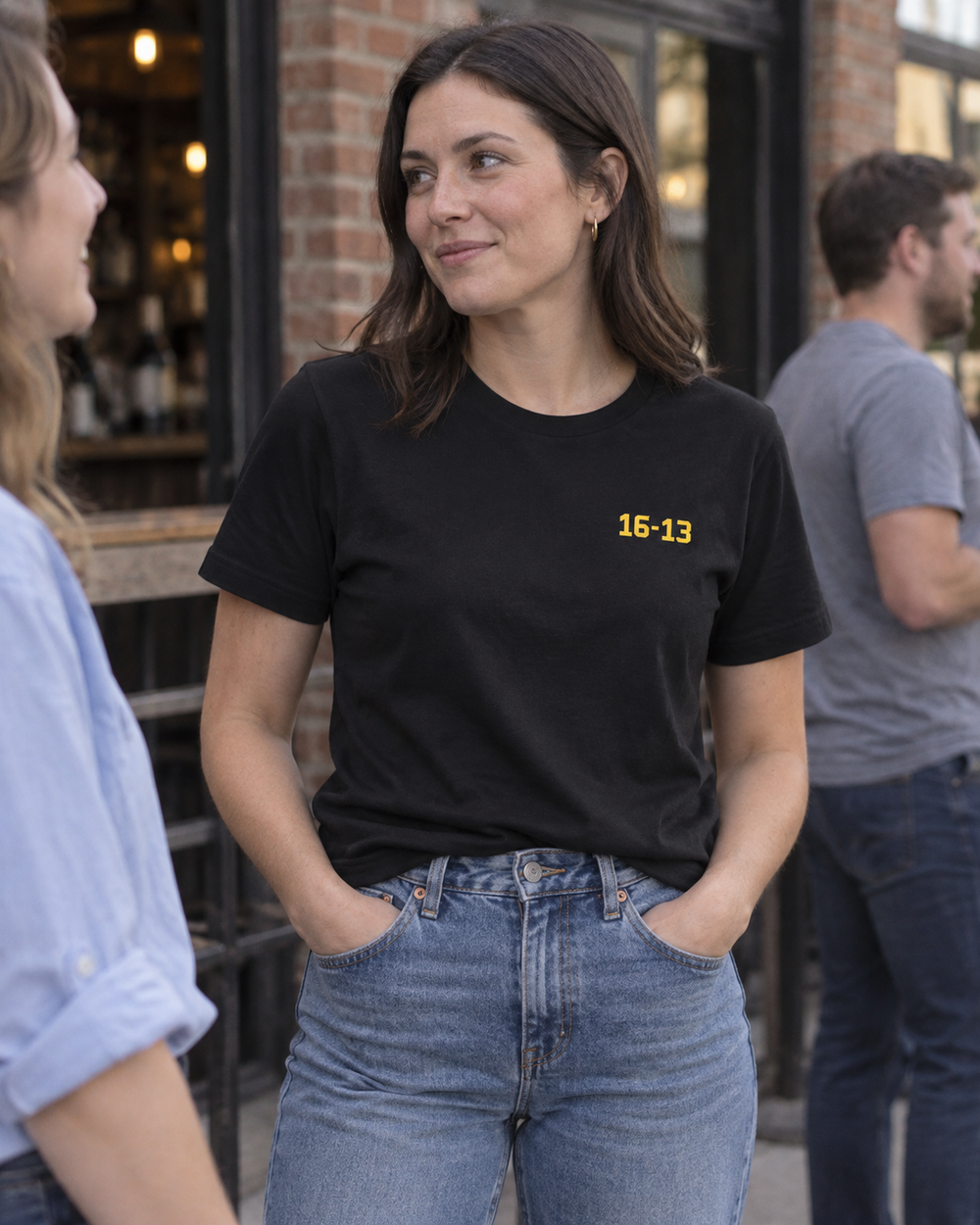 Woman wearing the unisex scoreboard tee, showing the small front score